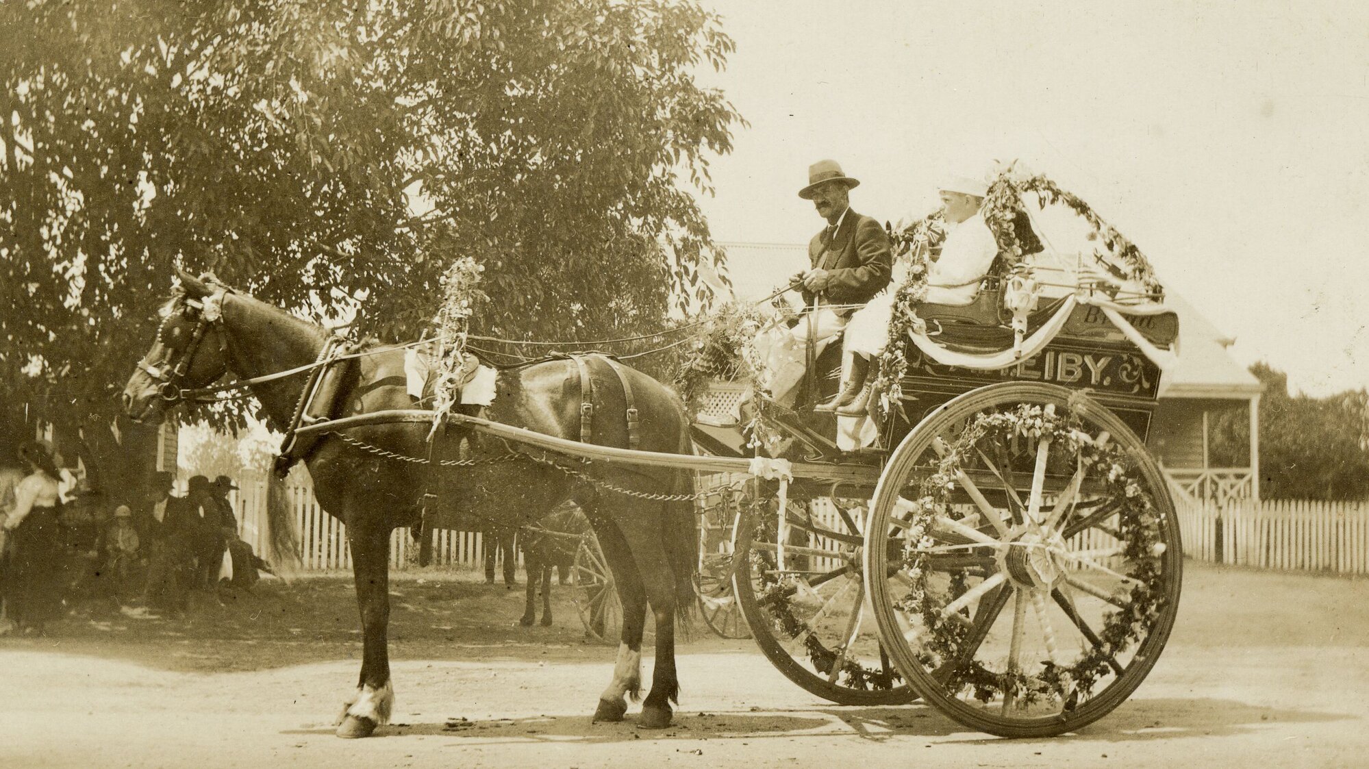 Archie Hathaway's father driving the best decorated vehicle in a carnival held in Caboolture in 1919
