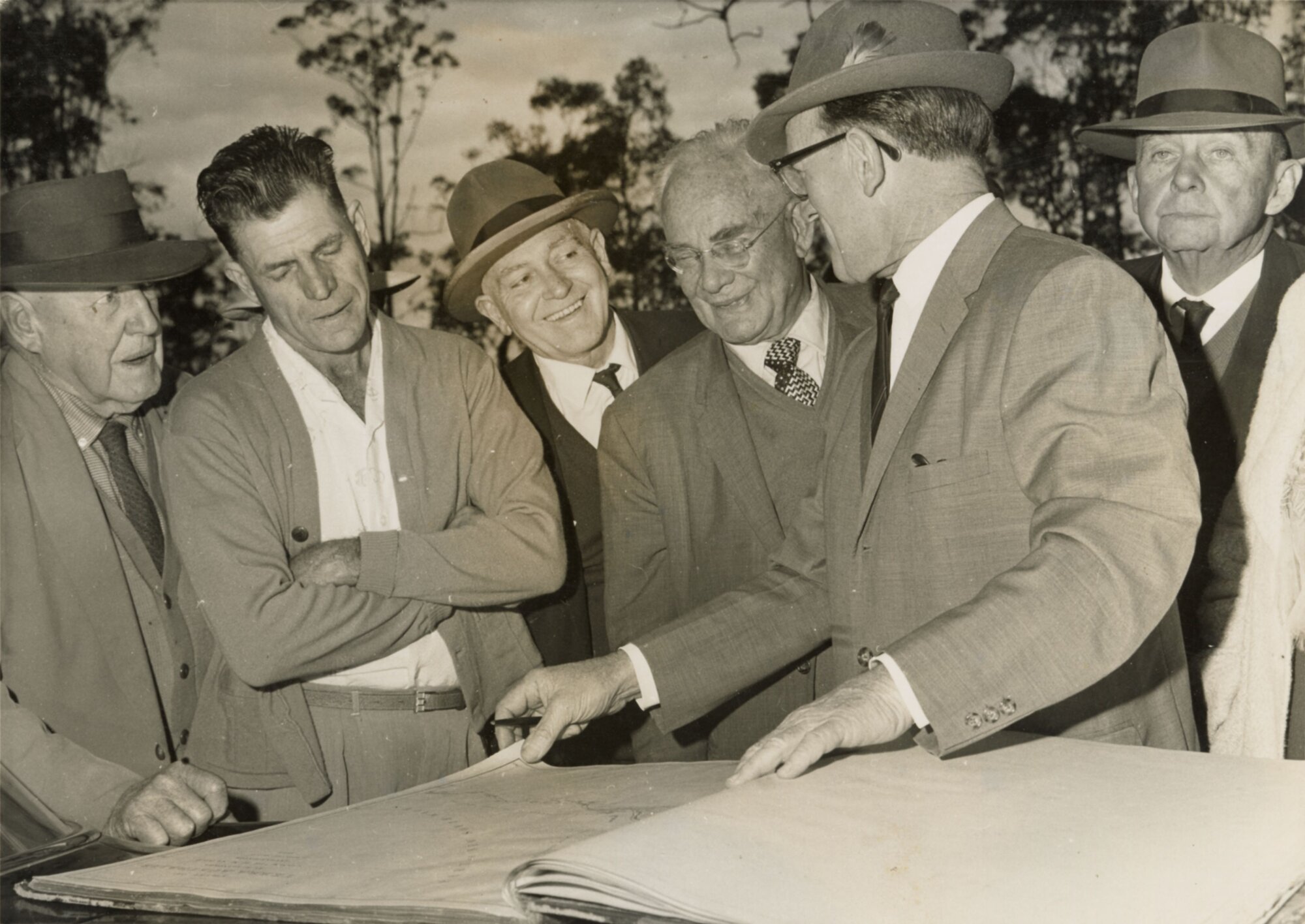The Honourable David Nicholson MP talking with Sir Raphael Cilento and others, ca. late 1960s