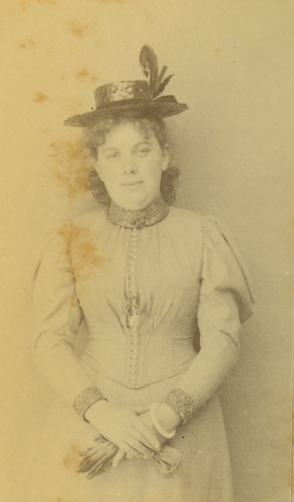 Portrait photograph of a young lady wearing a hat