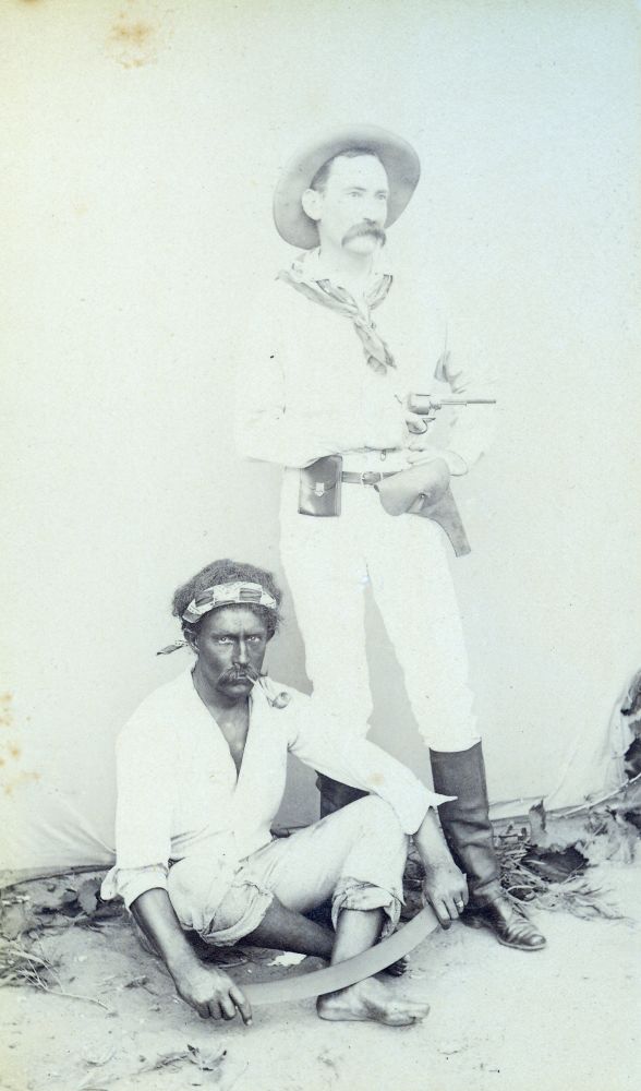 Photograph of two men with one holding a pistol