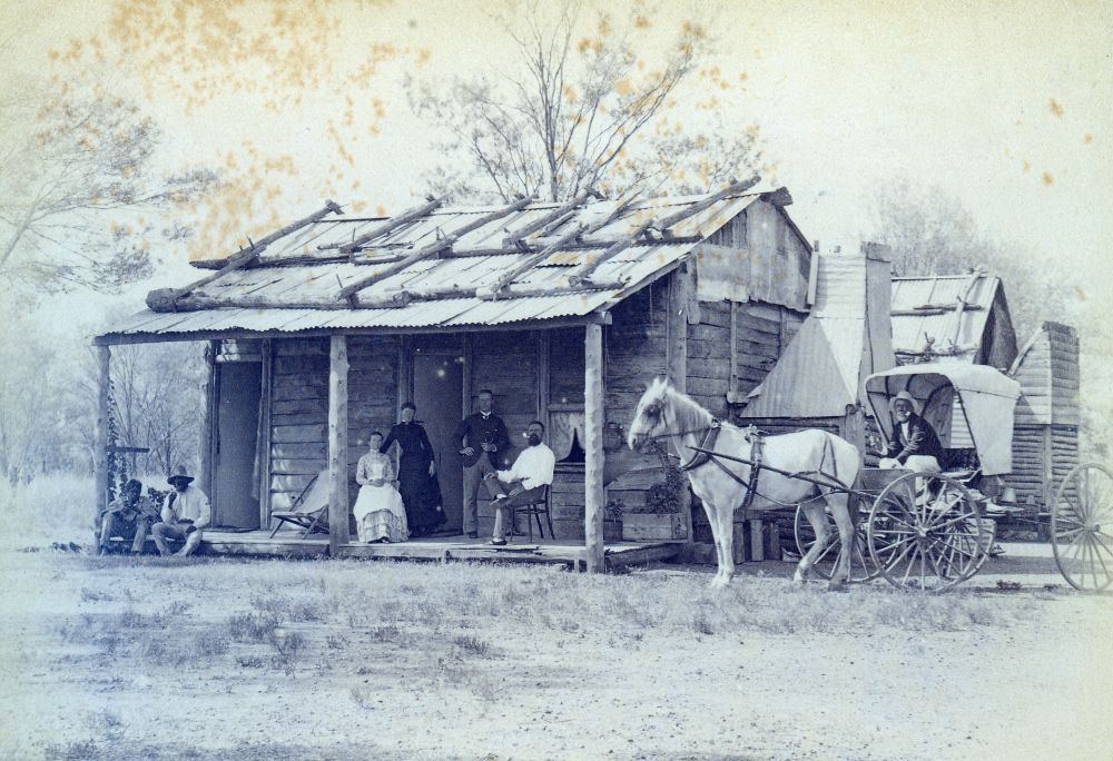 Small house with people on the front verandah