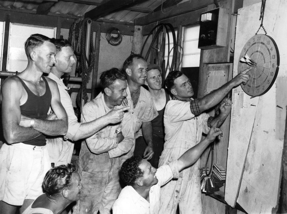 Workers playing a game of darts