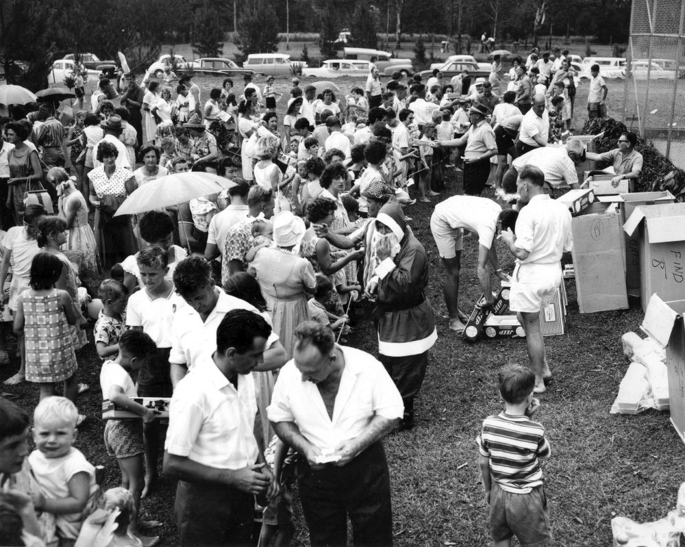 Children receiving their gifts at a Christmas party