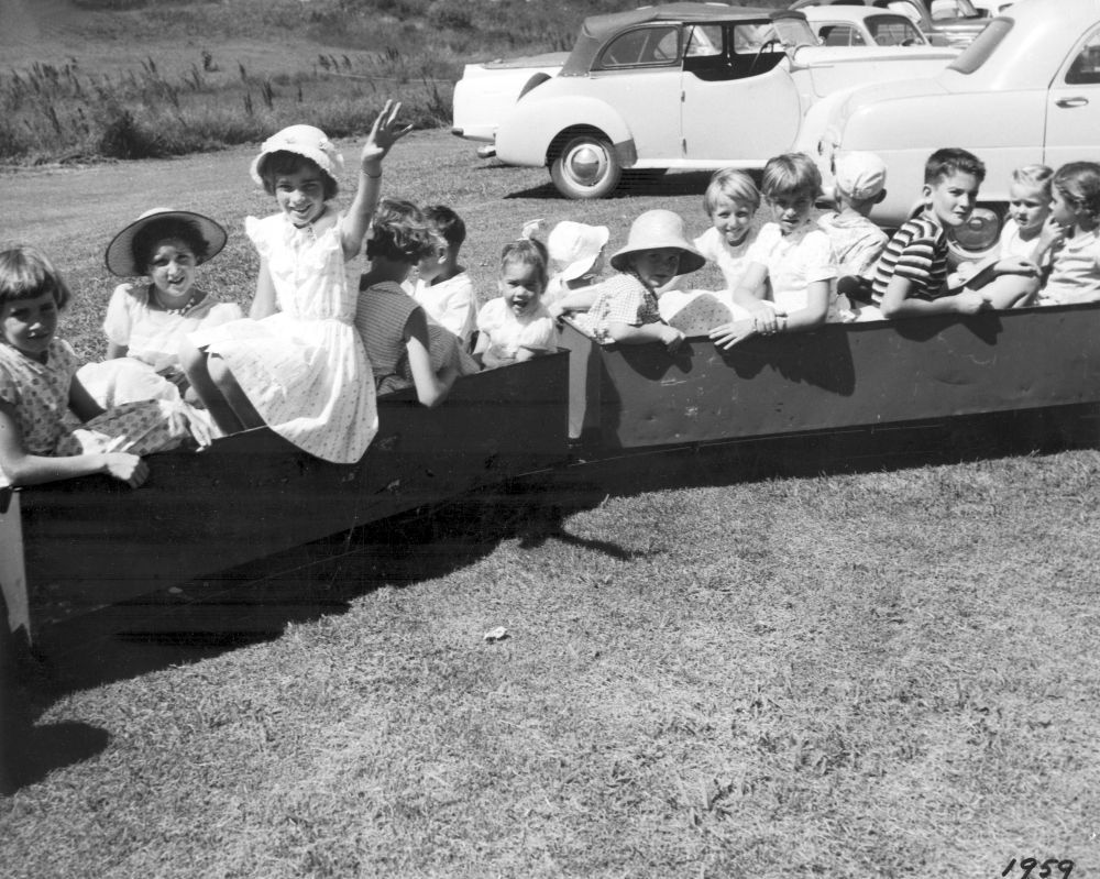 Children enjoying rides, 1959