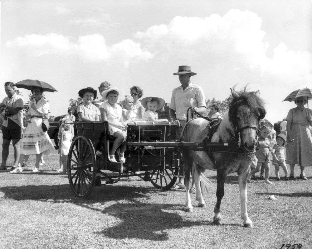 Children enjoying rides, 1959