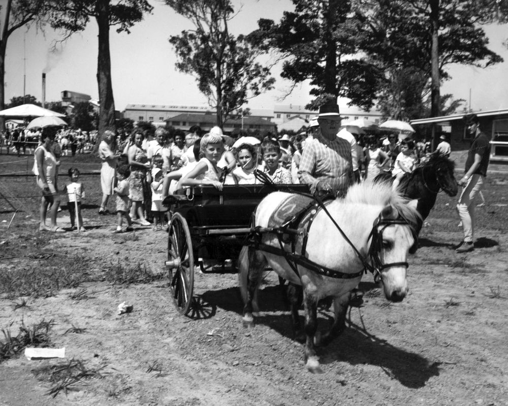 Children enjoying rides, 1966