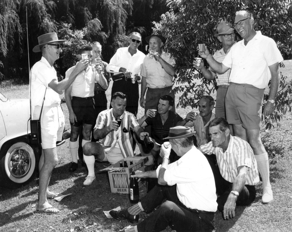 Group of workers enjoying a XXXX beer (Fourex beer)