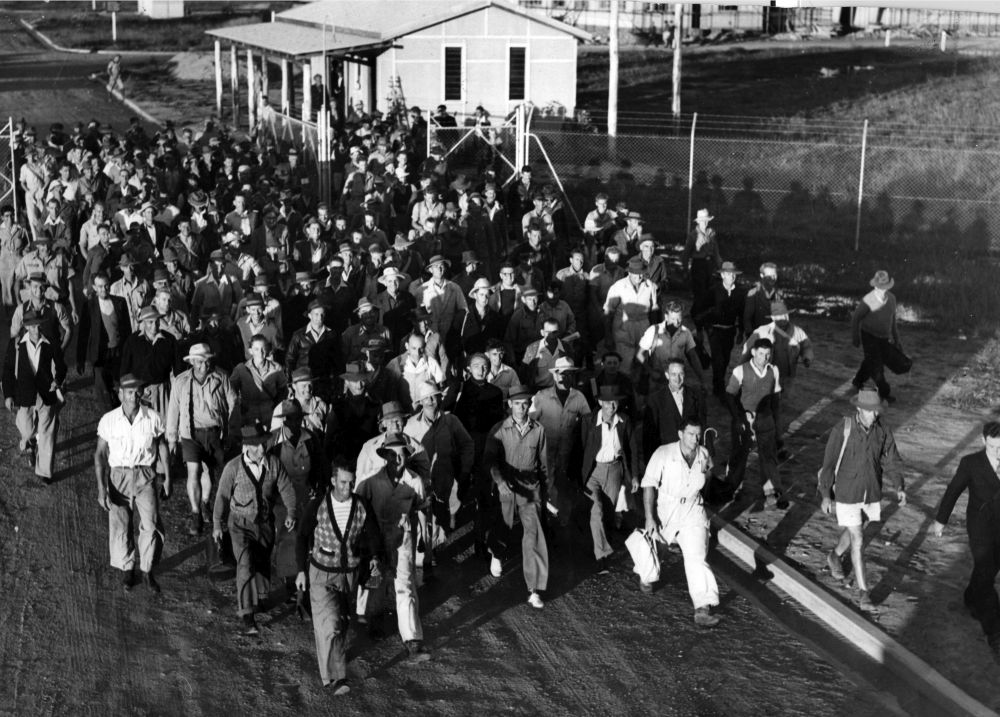 Workers leaving the Petrie Mill at the end of their shift, 1950s