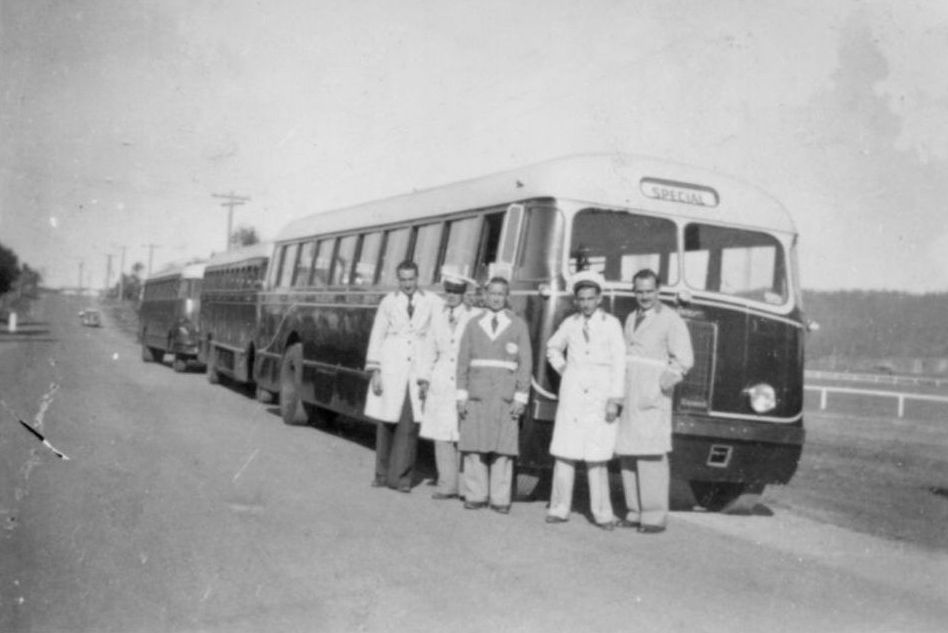 Bus drivers standing in front of three Dennis Lancet buses lined up on the roadside