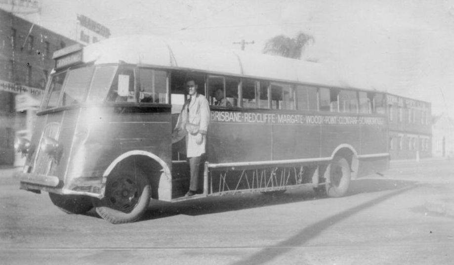 Bus conductor on step of the bus