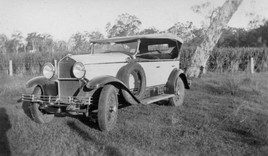 Car parked next to a field