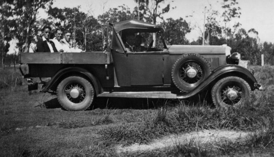 Group of men sitting in back of truck