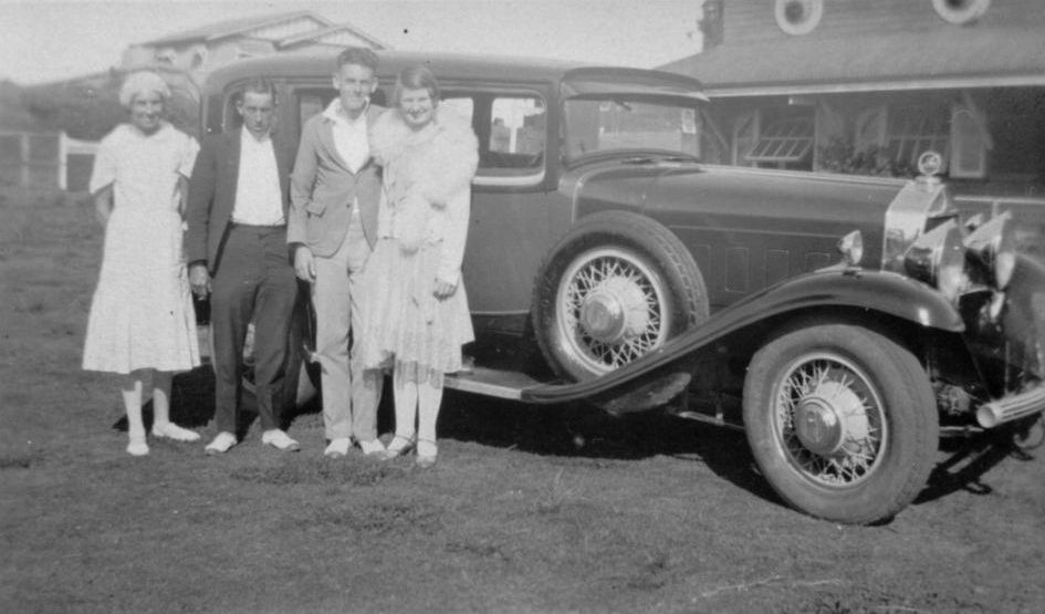 Group standing alongside a car