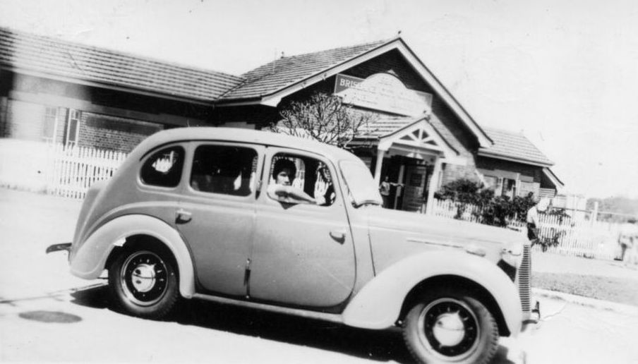 Young man sitting in driver's seat of car