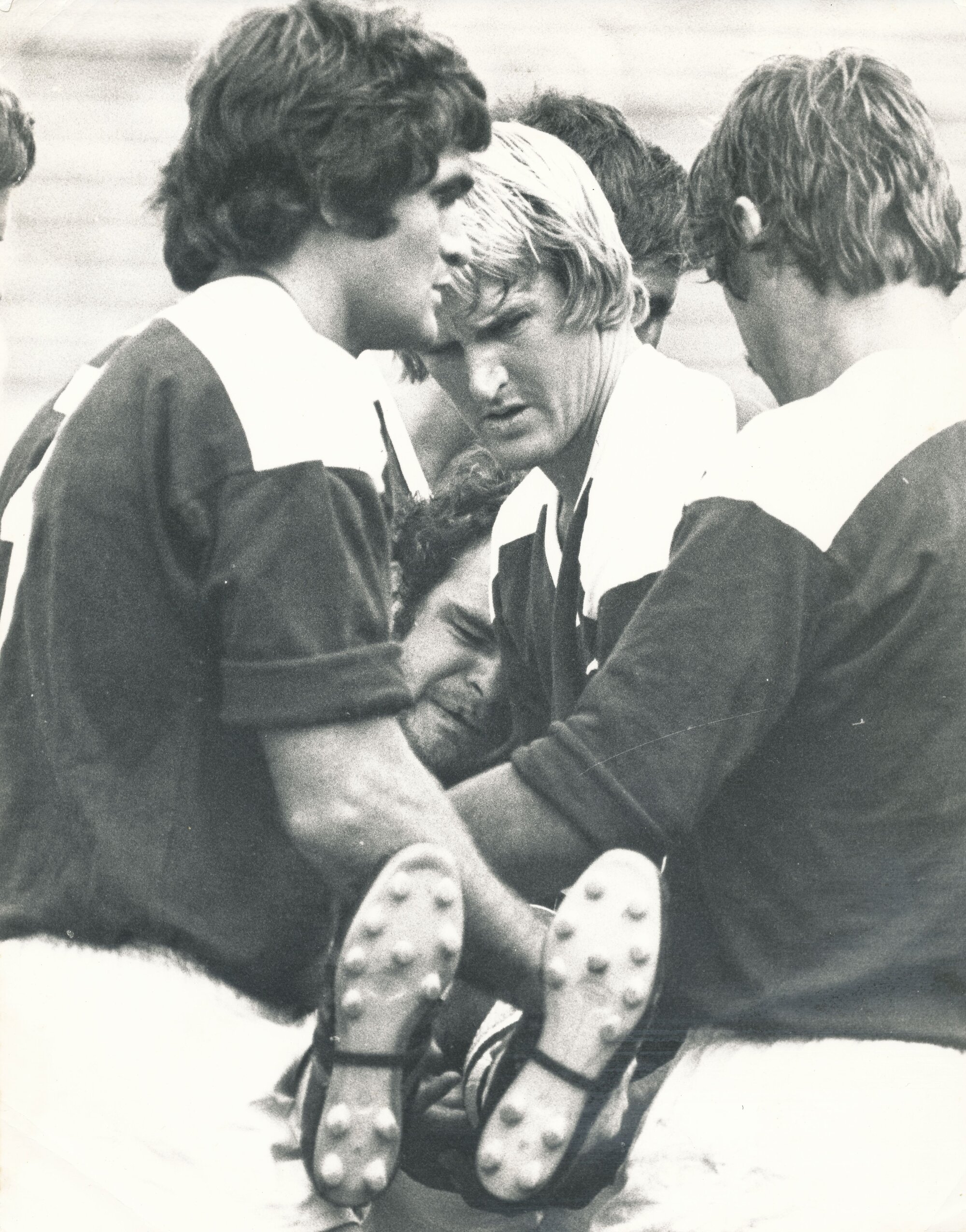 Injured player being carried from field by Vic Tighe