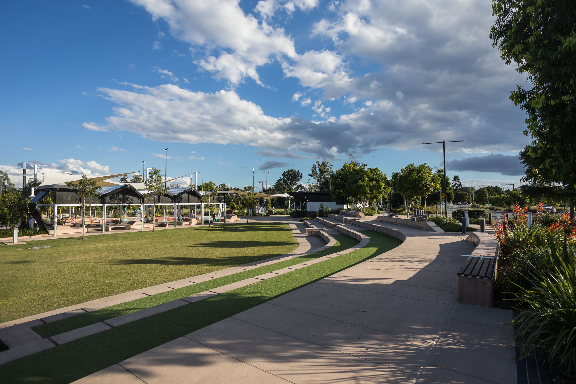 Lawn and tiered seating area at The Mill water park and adventure playground - 12 Moreton Parade Petrie