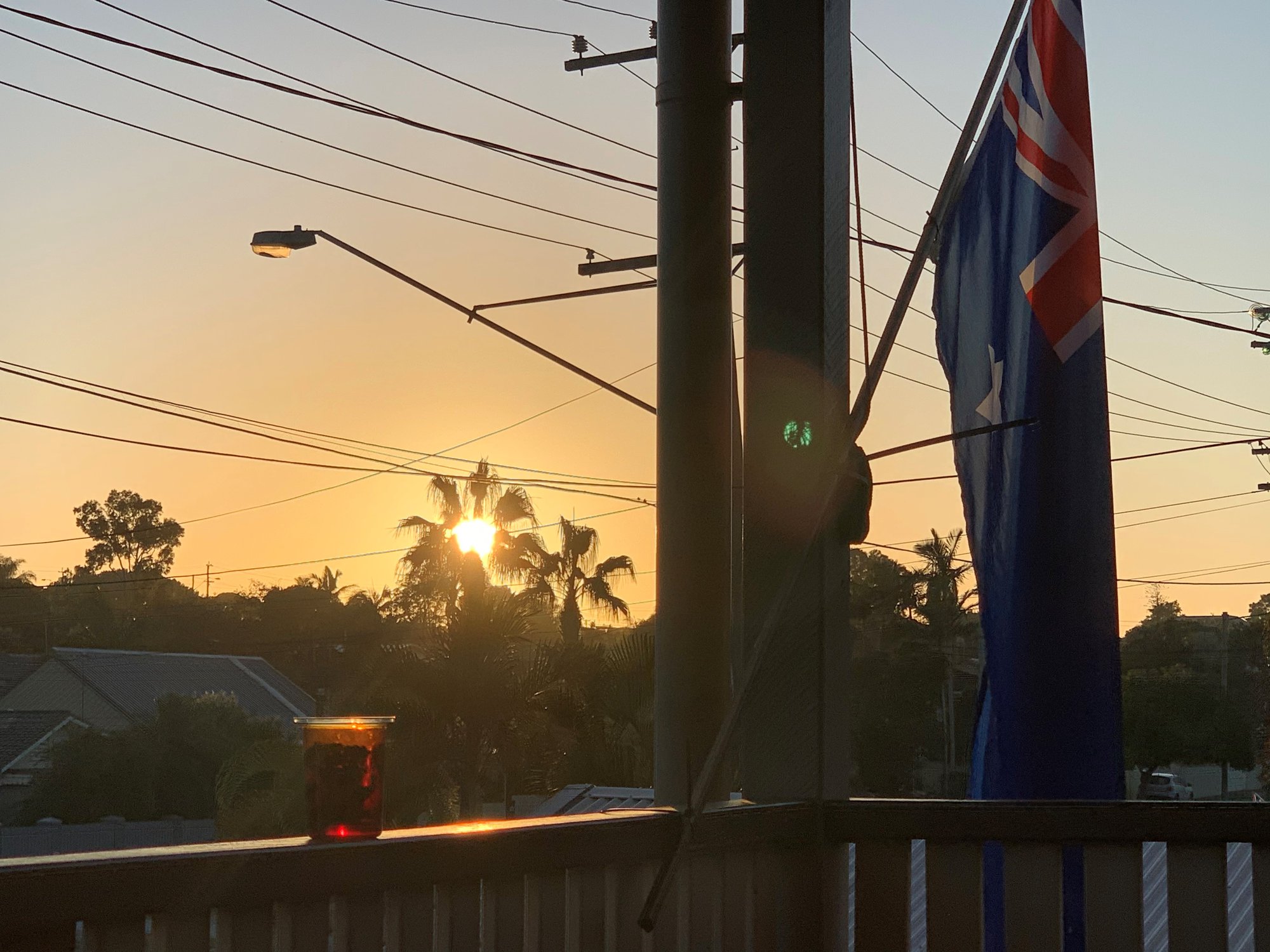 Griffith Road Scarborough - 25 April 2020 - Australian flag on balcony at dawn - 002