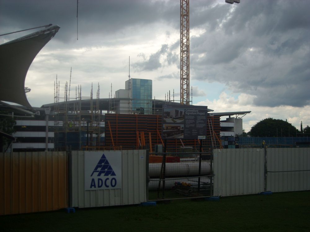 Working on the external walls and the floor at the construction site of the Caboolture Hub, 4 Hasking Street Caboolture