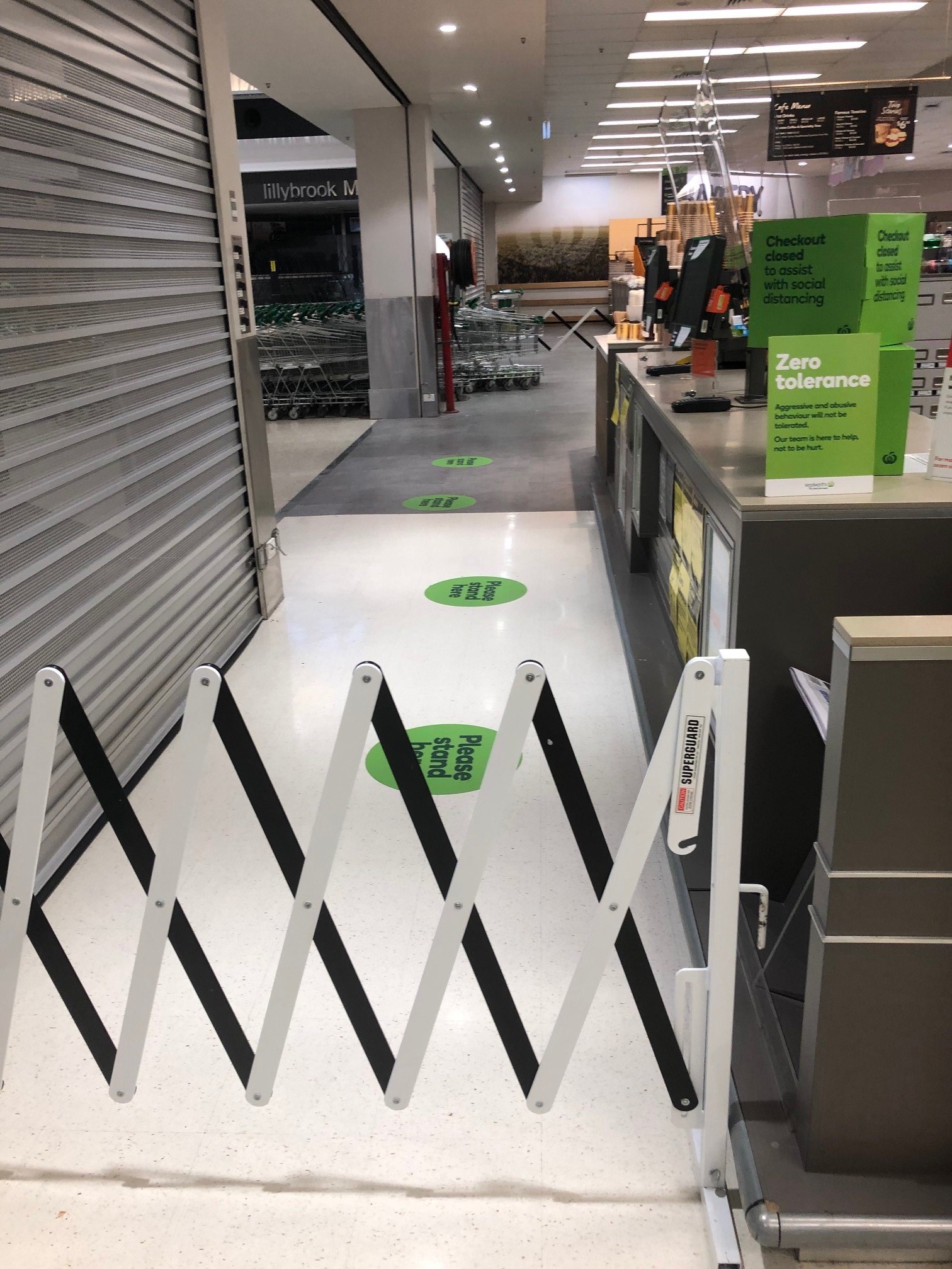 Woolworths Supermarket - Warner Marketplace Samsonvale Road Warner - 10 April 2020 - signage and barrier to create single exit