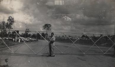 Worker Opening Main Gate