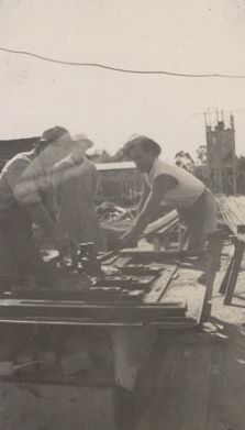 3 Men working on machinery for mill construction