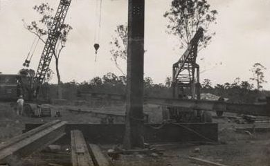 Two cranes lifting a girder