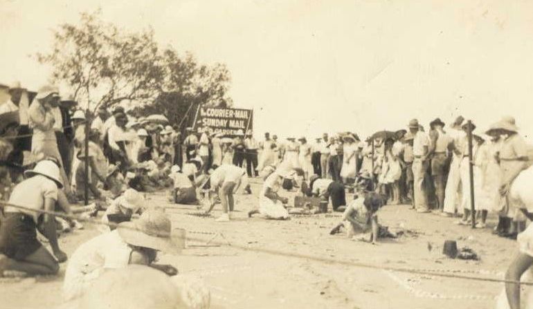 Contestants in a competition form sandy borders before making patterns out of shells
