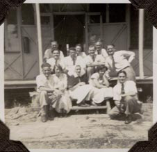 12 Male &amp; Female Staff Members on steps of first office