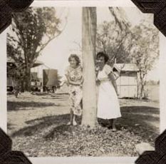 Two Female staff under palm tree