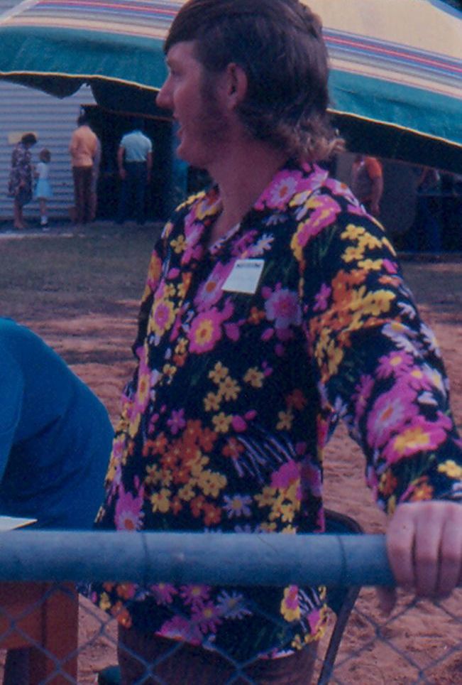 Unidentified person with bright shirt and classic mullet hair style