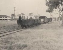 Train with guard perched on rear truck