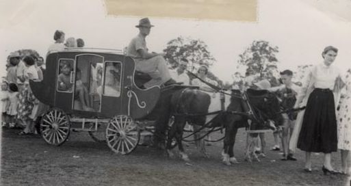Children in a miniature stage coach