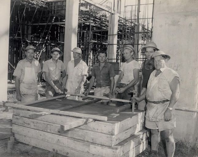 Group photograph - standing near timber pallets