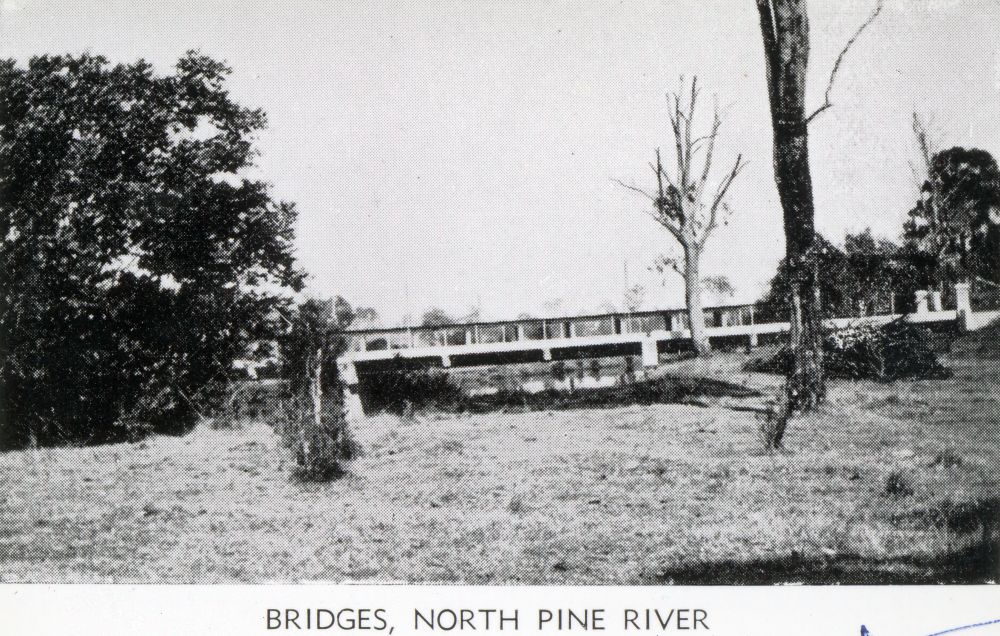 Postcard showing the road bridge and railway bridge over the North Pine River, Petrie in the 1930s
