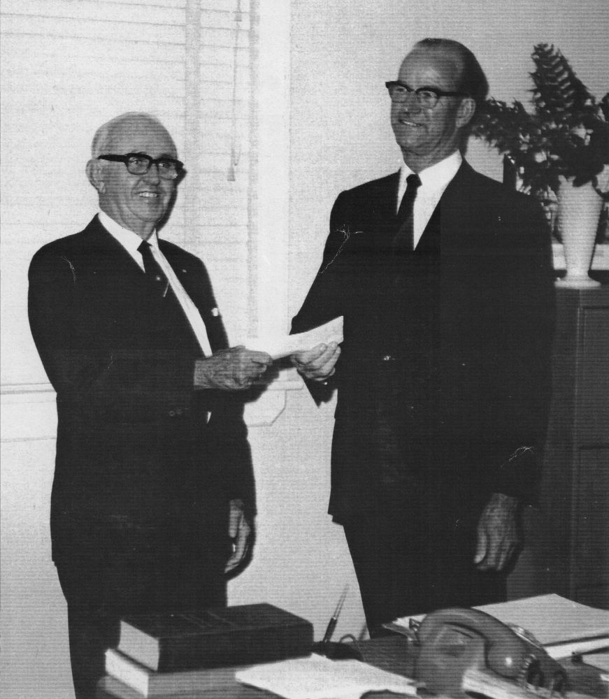 Pine Rivers Shire Council Chairman, Cr John Sanders Bray, receiving a cheque for $1,000,000.00 from a bank manager