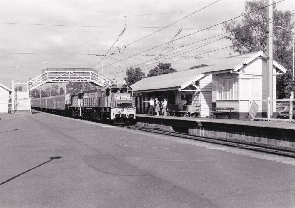 Diesel passenger train arriving at Petrie Railway Station, 1988