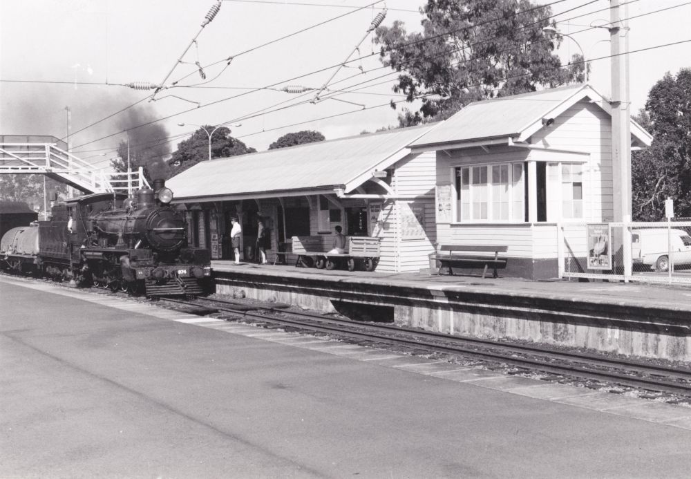 Steam train passing through Petrie Railway Station, 1988