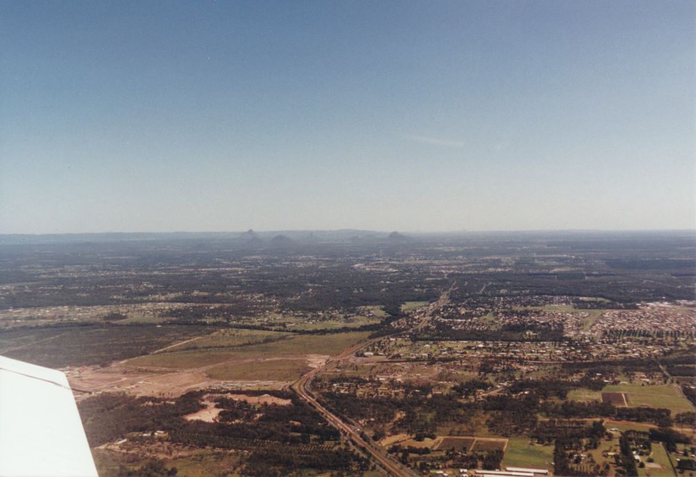 Aerial view towards the Glass House Mountains (Qld.), 1996