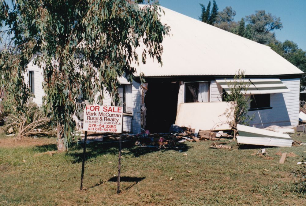 House washed from it foundations during floods in Charleville (Qld.), 1990