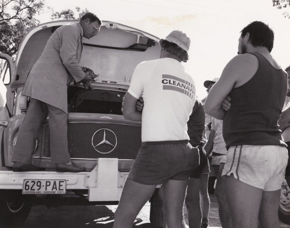 Demonstration to a group of men about an old truck