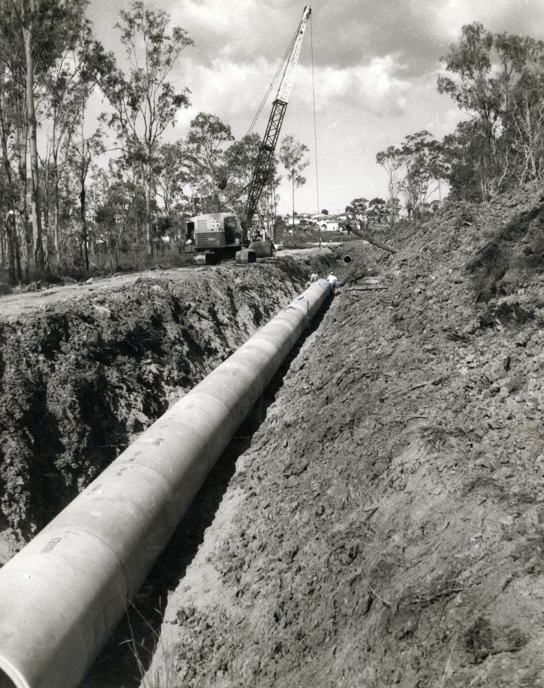 Laying drainage pipes on the site of a future rubbish dump at Lawnton, ca. 1970s
