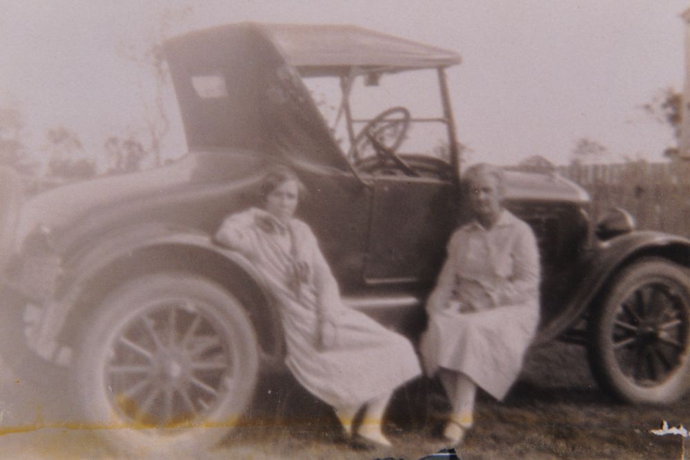 Two women with a vintage car, ca. 1930s