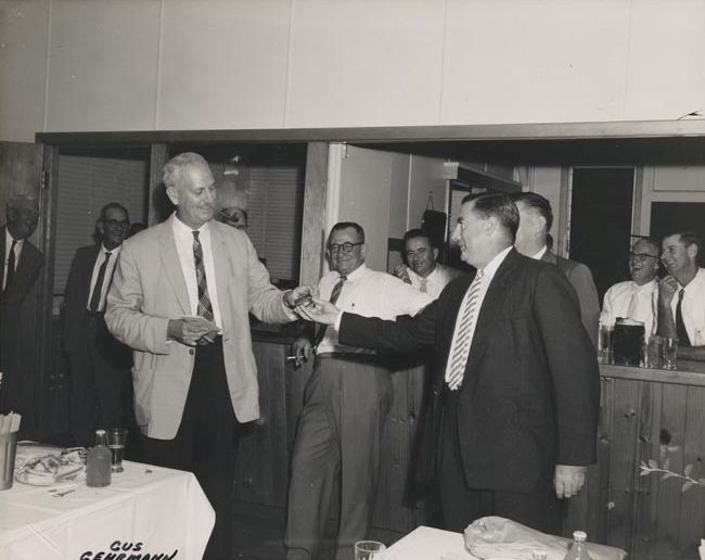 Gus Gehrmann - R.D.M. standing near table