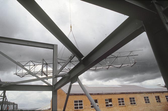 Working on steel frame construction outside building