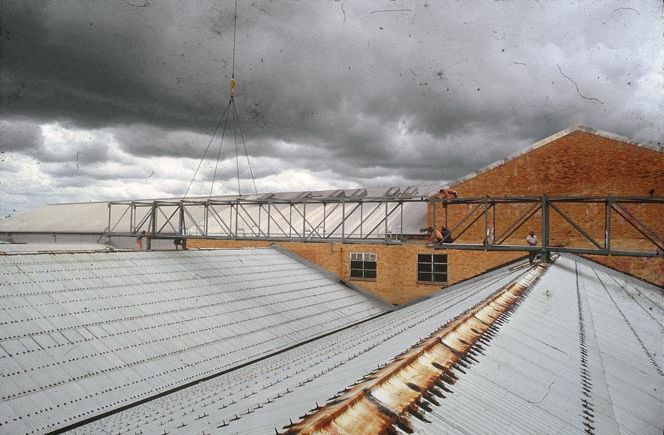 Working on steel frame construction outside building