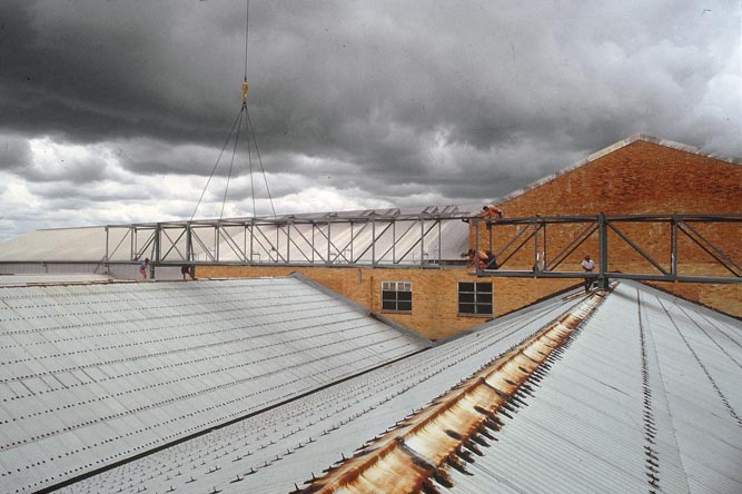 Working on steel frame construction outside building