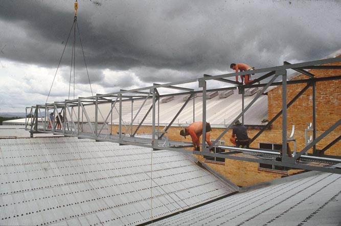 Working on steel frame construction outside building