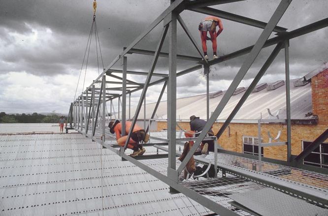 Working on steel frame construction outside building