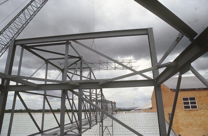 Working on steel frame construction outside building