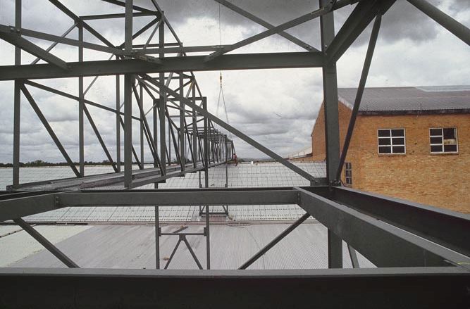 Working on steel frame construction outside building